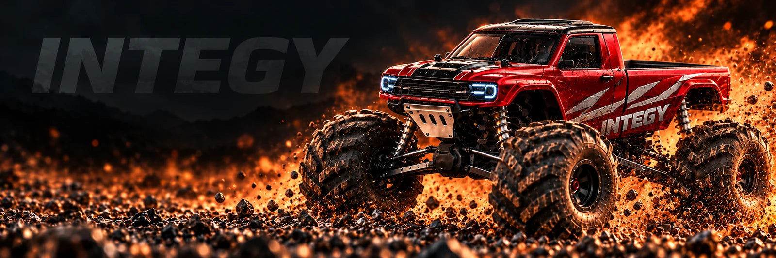 Red INTEGY RC monster pickup with integrated silver body graphics, oversized tires, lifted suspension and gravel action